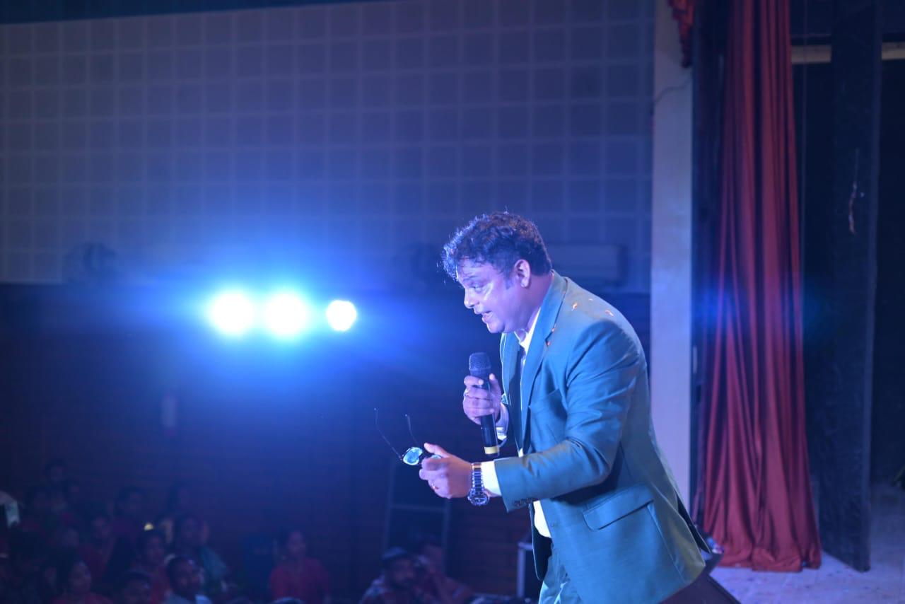 Raja Saha with microphone on stage